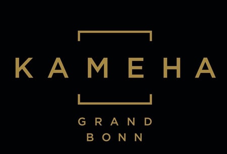 Goldene Schrift KAMEHA GRAND BONN auf schwarzem Hintergrund, im Kontext einer Patienteninfoveranstaltung zum Mako-Roboter im Kameha Grand Hotel.