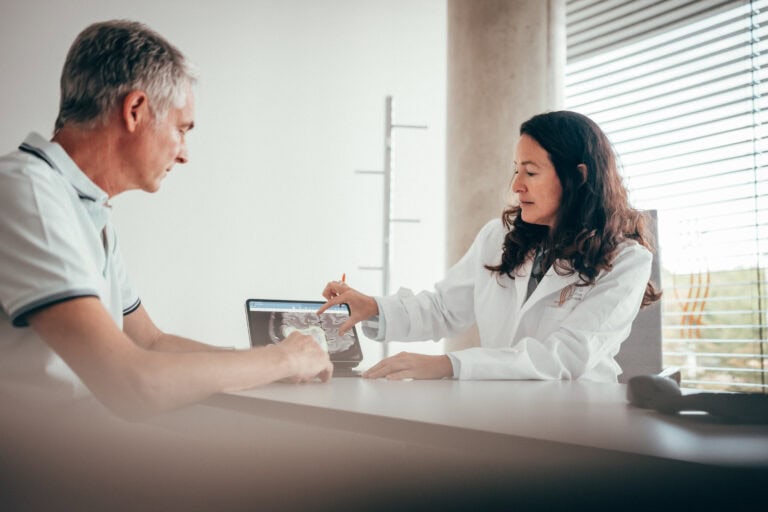Frau Prof Rapp erläutert einem Patienten die Diagnose anhand einer MRT Untersuchung